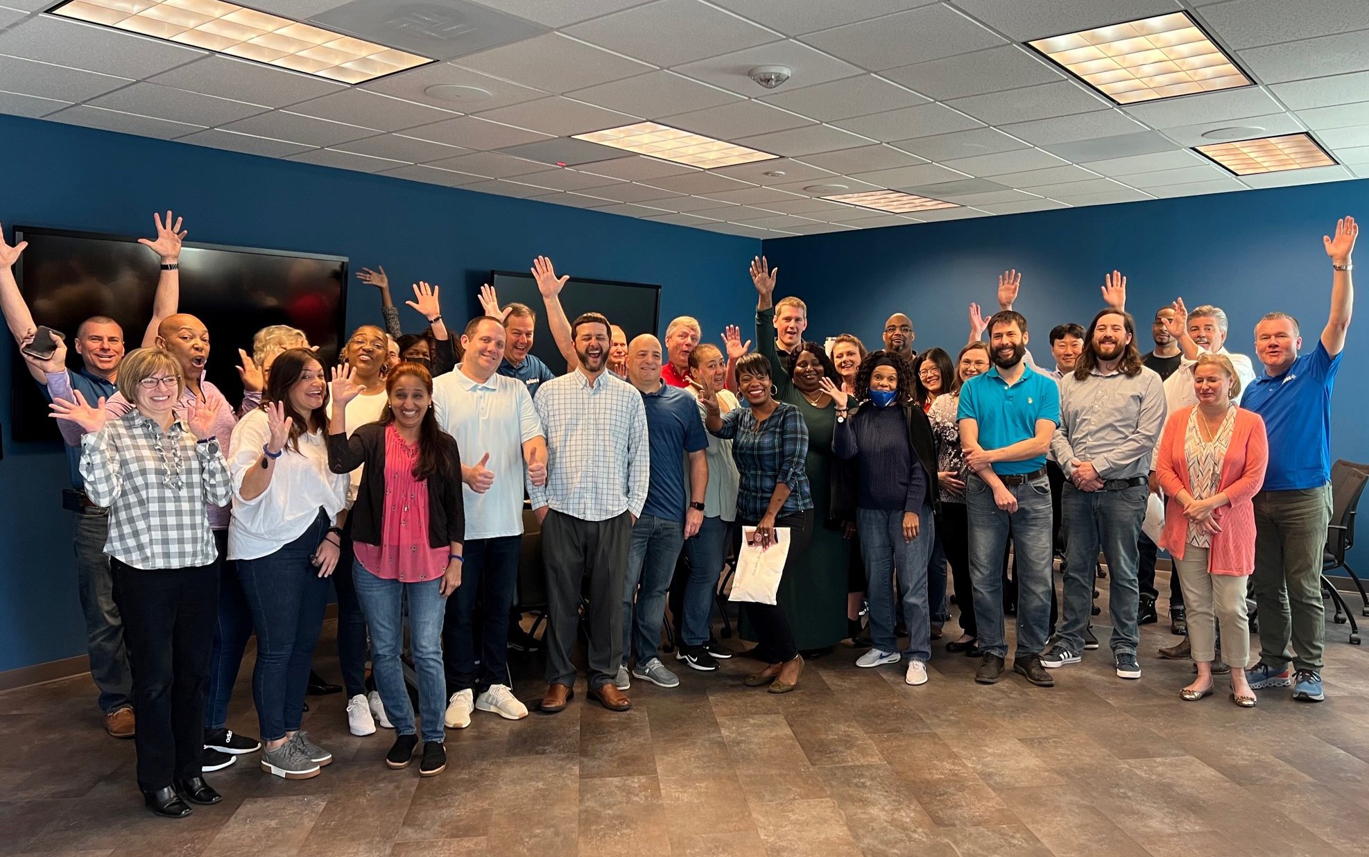 Group of Avidex Cary team members waving and smiling