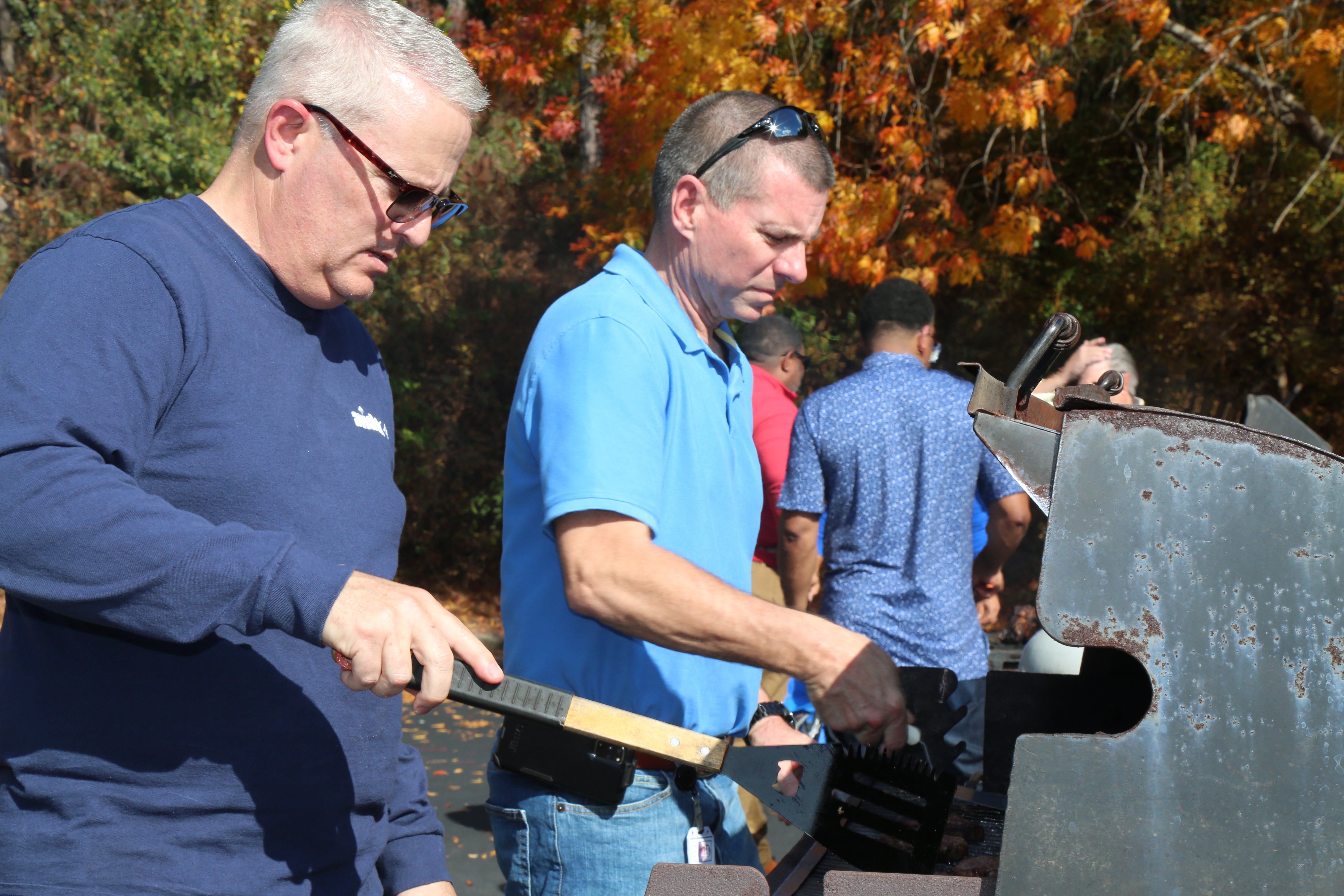Avidex team members preparing food during company cookout event.