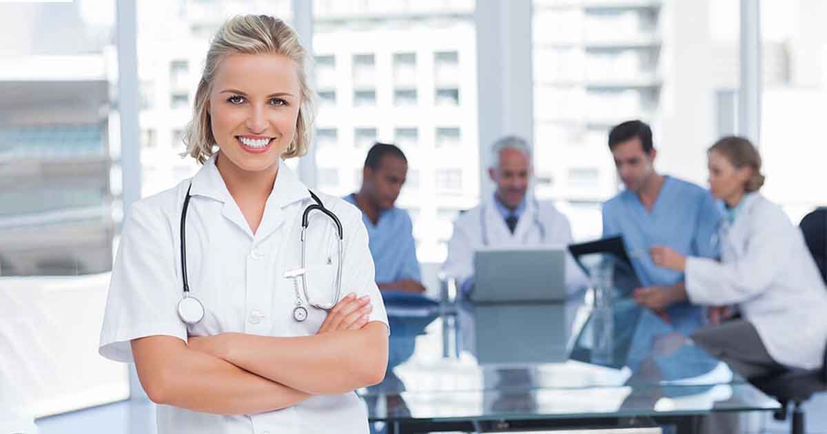 Nurse smiling in front of team