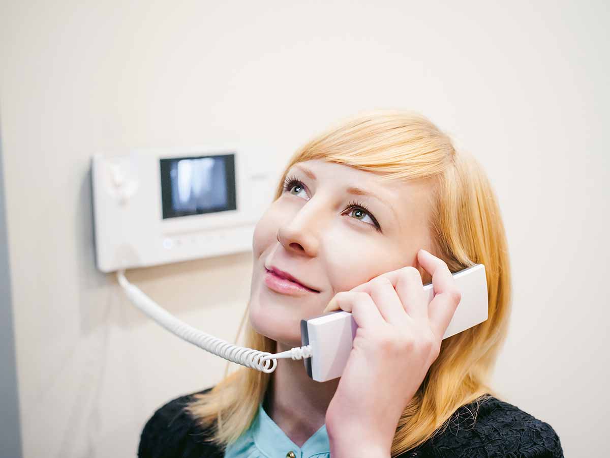 Woman using a phone paging system
