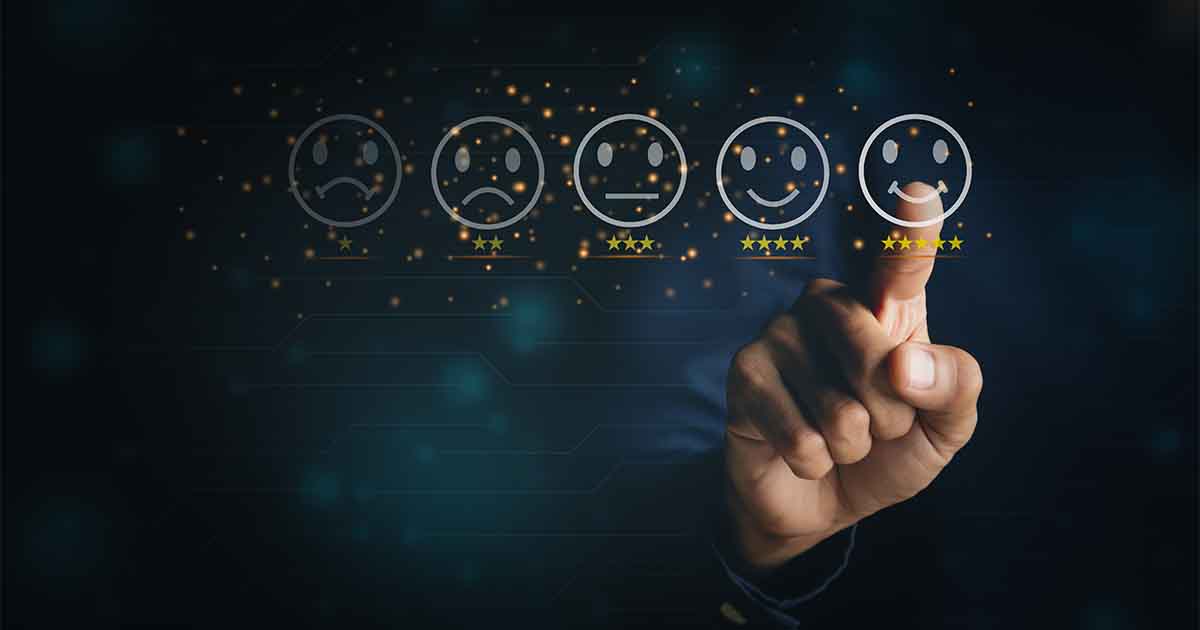 a finger pointing to a smiley face with progressively sadder faces to the left