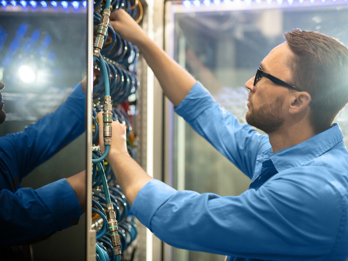 A data center engineer examining cables