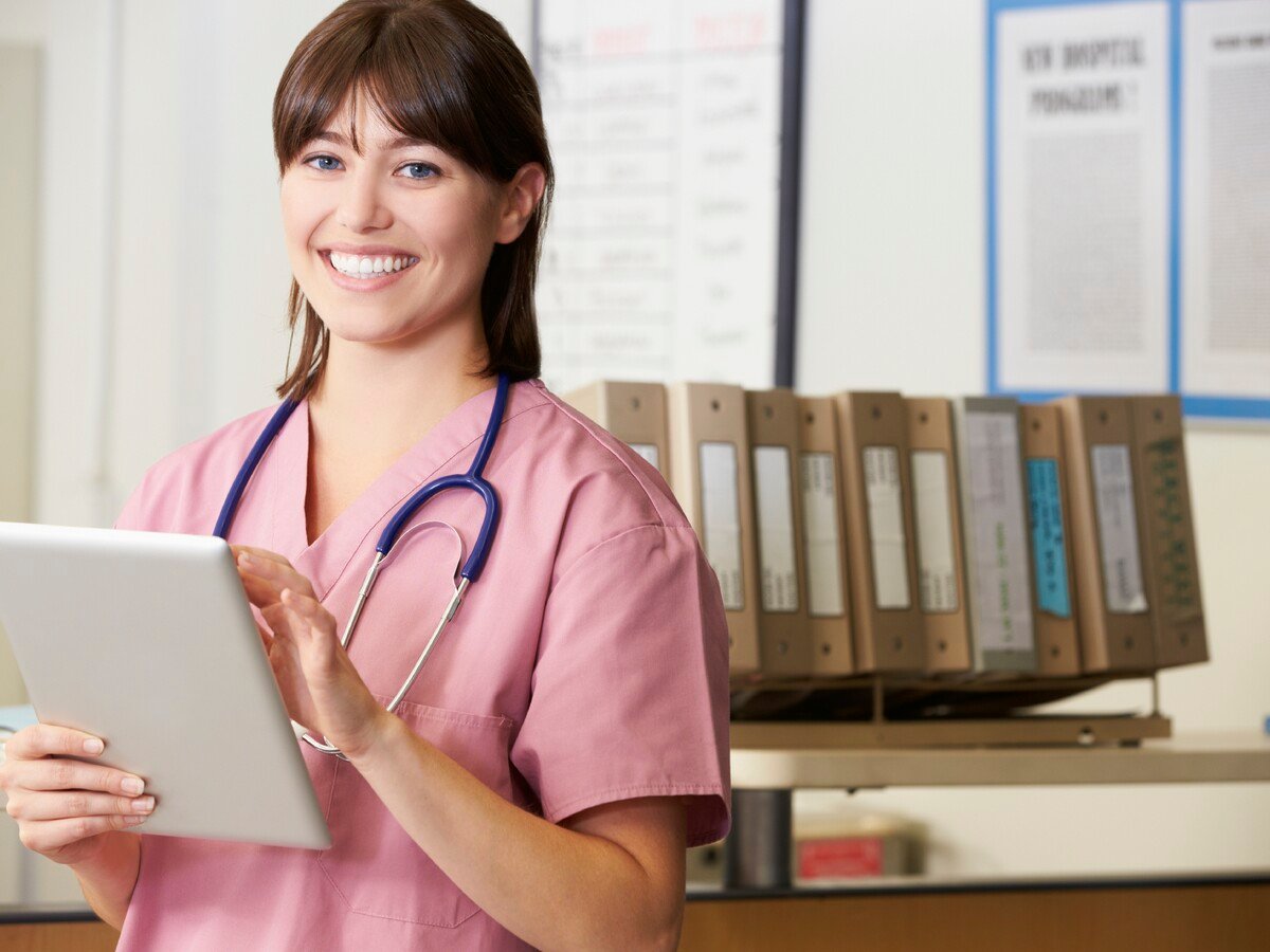 A female medical working smiling holding an IPad