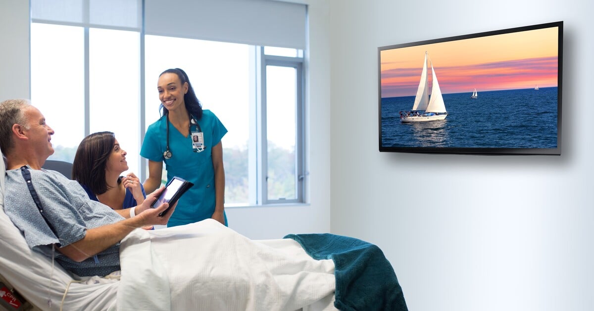 Patient Watching TV with spouse and nurse in the room