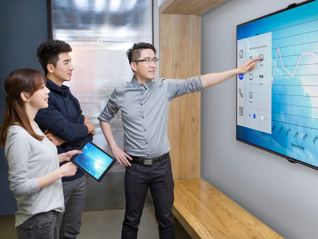 Group of educators using interactive wall display