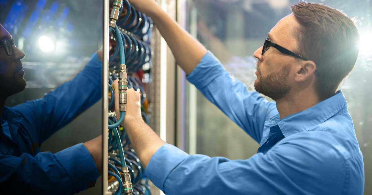 Service Tech examining cables